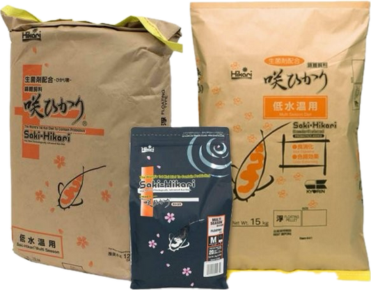 Multiple bags of Saki-Hikari Multi Season wheat-germ koi food with medium or large pellets—premium Hikari koi food for year-round color and growth.